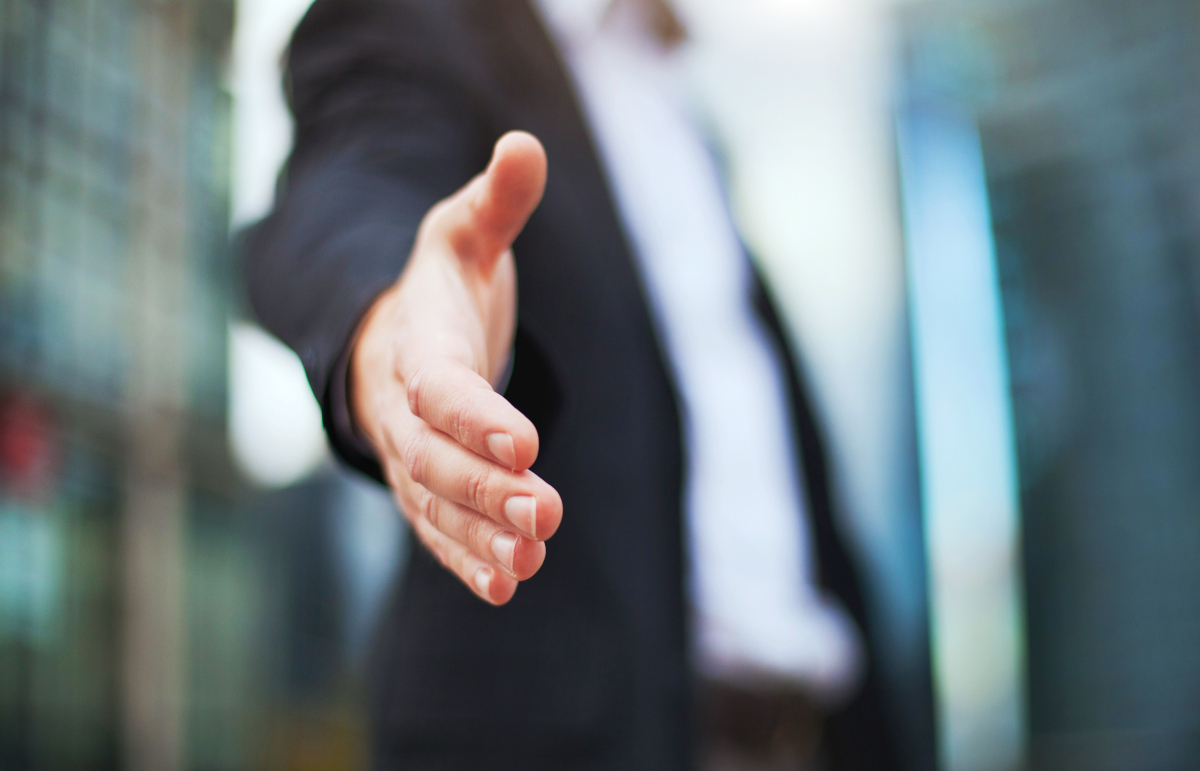 Close Up of Businessman Reaching Hand Out for Handshake